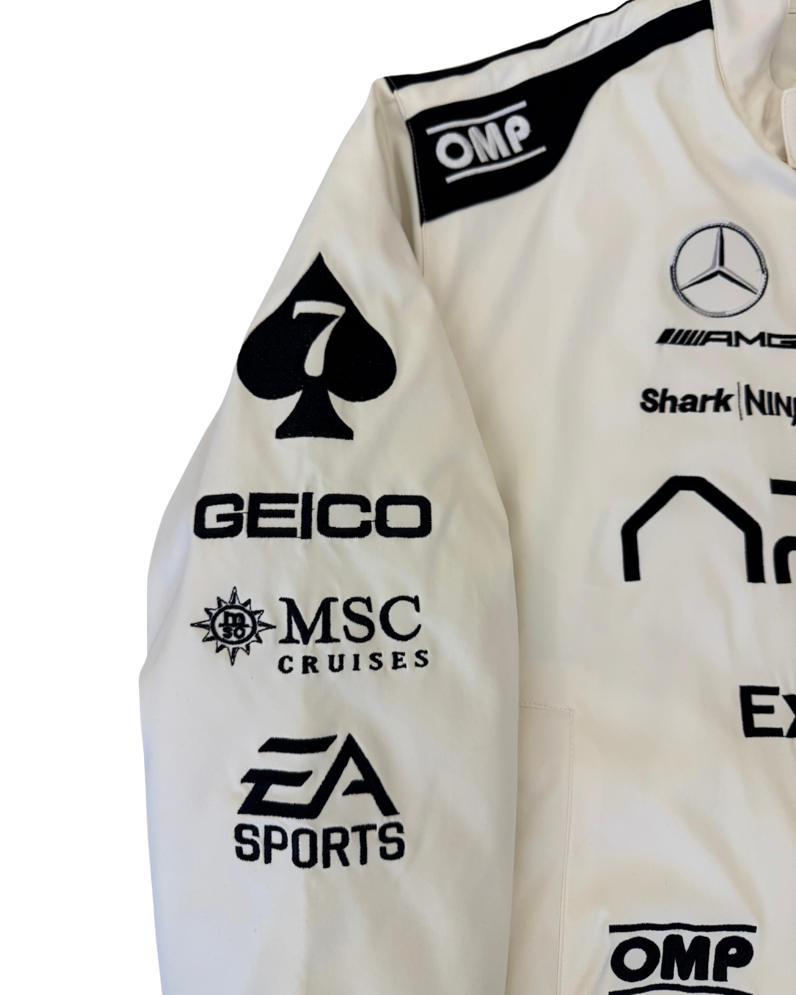 Close-up of APX GP F1 movie jacket chest with IWC patch and APX GP logo branding
