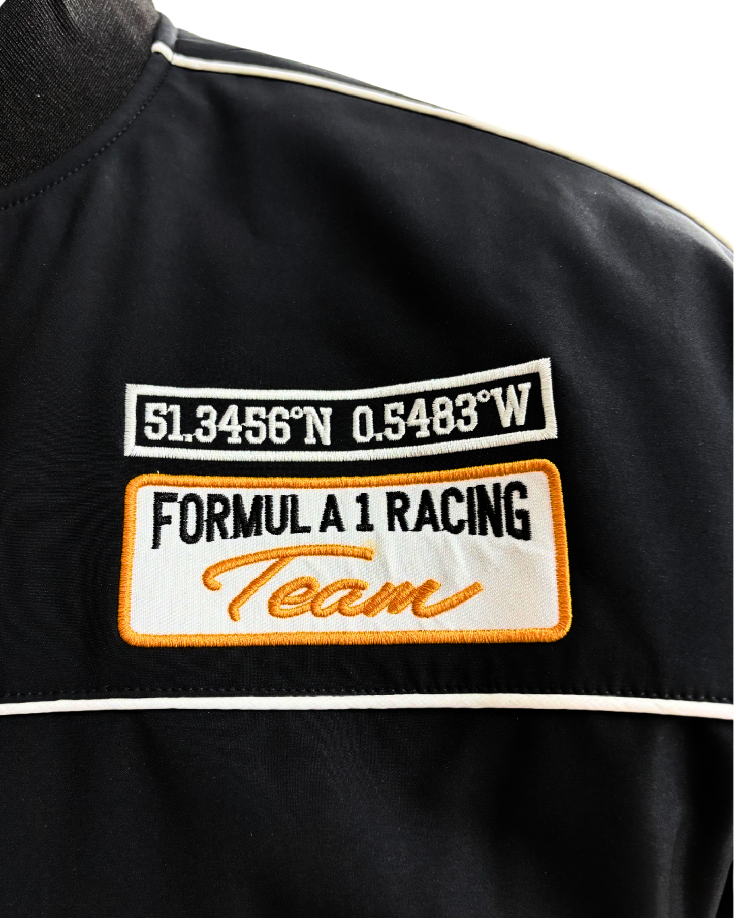 McLaren racing jacket sleeve with embroidered McLaren logo and orange accent stripe