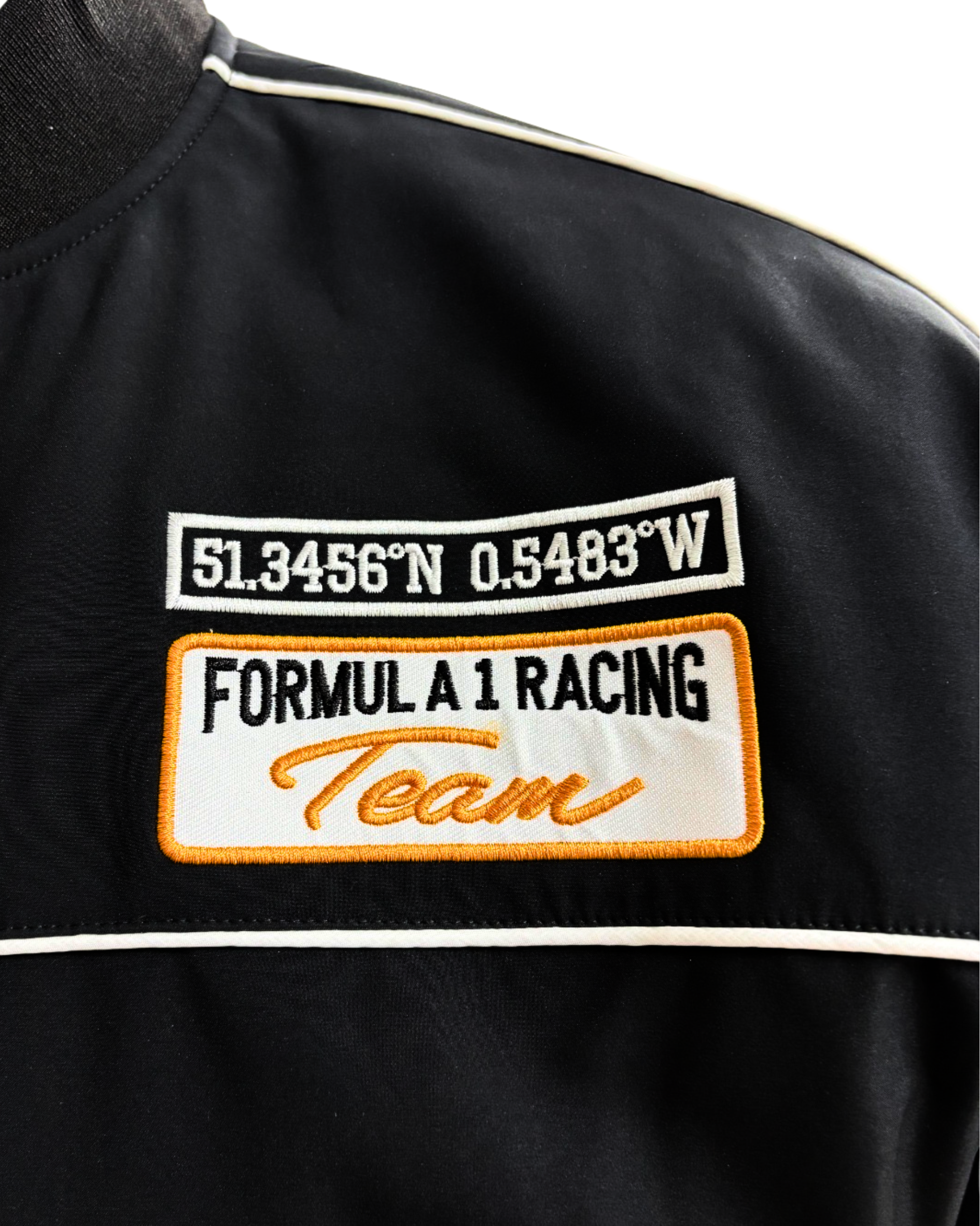 McLaren racing jacket sleeve with embroidered McLaren logo and orange accent stripe