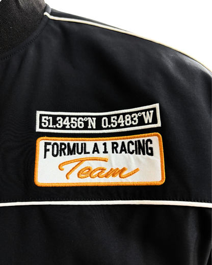 McLaren racing jacket sleeve with embroidered McLaren logo and orange accent stripe